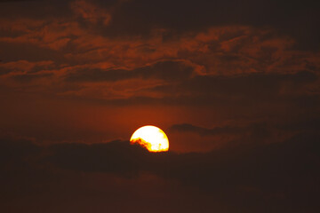The sun is behind the clouds in the morning. Morning atmosphere.