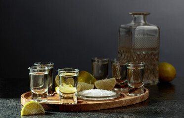 Gold tequila with salt and lime slices.
