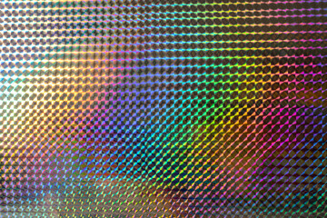 A vibrant, iridescent pattern of diamond shapes reflecting various colors, creating a mesmerizing visual effect reminiscent of art and design.