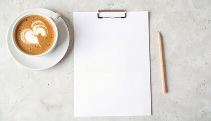 Coffee cup with heart design beside blank paper on table, mockup