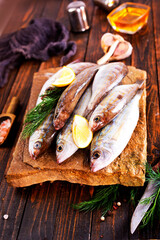 Fresh small fish on stone board