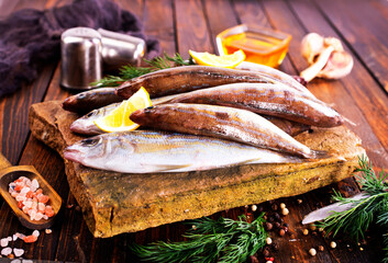 Fresh small fish on stone board