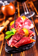 sliced smoked meat with red wine. The concept of cooking meat,