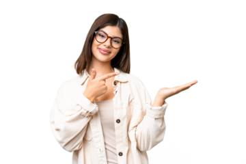 Young Russian woman over isolated chroma key background holding copyspace imaginary on the palm to insert an ad