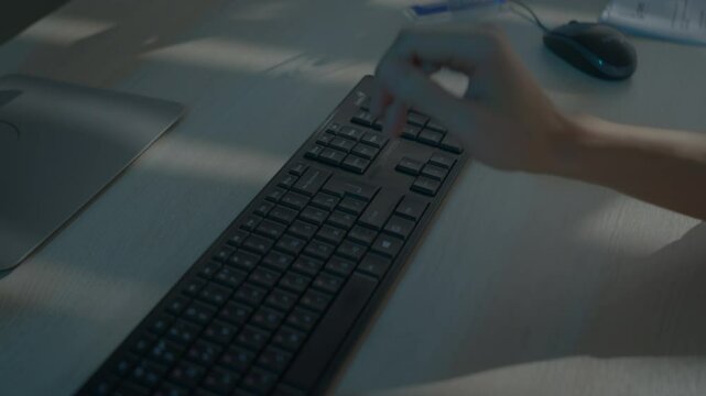 Man fingers tap rapidly on dark computer keyboard. Every keystroke forms crisp message with precision. Text unfolds with measured precision