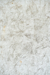 Grey rough wall texture concrete like stone with a mixture of rice straw dry hay.