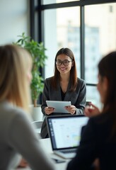 Obraz premium Collaborative Innovation: Diverse Team in Modern Office Meeting, Led by Asian Woman with Tablet, Engaging in Problem-Solving and Communication