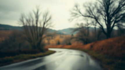 Fototapeta premium A soft, blurred background showcasing a misty landscape with trees and distant hills, creating a tranquil and atmospheric scene ideal for nature-themed projects.