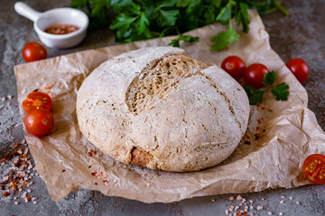 Homemade rye bread on parchment. A loaf of homemade bread for dinner. Close-up