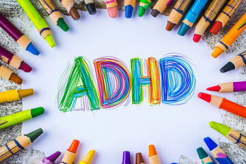 AUTISM, ADHD, written with colored pencils.