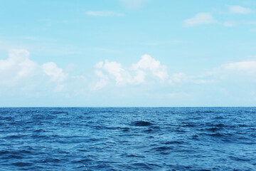 Fototapeta premium Landscape of horizontal calm blue sea with wave and cloud and blue sky in bright day. Travel destination summer of ocean in Asian. Copy space 