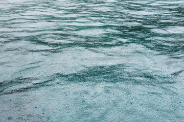 Fresh of the rain falling on the calm sea surface with feeling of relaxation and peace in tropical natural seasonal