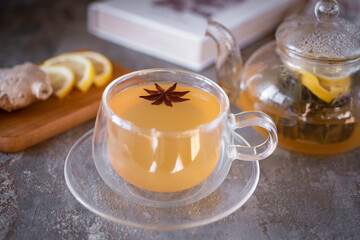 Beautiful cup of hot ginger tea. Ginger tea in a cup and ginger tea in a teapot for breakfast. Close-up