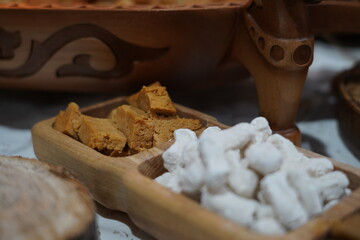 Kazakh traditional sweets in wooden cups.