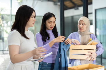 Women collaborating on sustainable donation efforts with recycled items