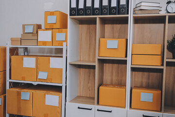 Asian SME business women use laptop computer checking customer order online shipping boxes at home. Starting Small business entrepreneur SME freelance. Online business, Work at home concept.