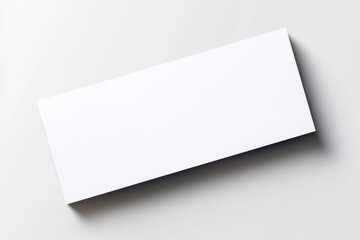 Plain white envelope resting on a light grey background showcasing minimalist design and simplicity in packaging