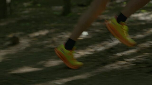 Woman in sportswear shows spirited speed running through dense forest . Determined stride blends athletic strength with forest beauty
