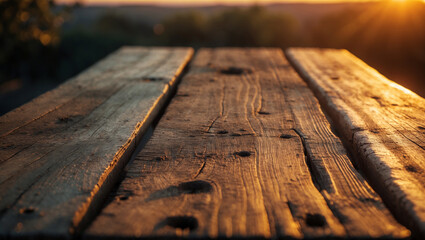 A detailed close-up of a rustic wooden table with deep textures, bathed in golden sunset light. A perfect background for outdoor dining, nature retreats, and rustic aesthetics