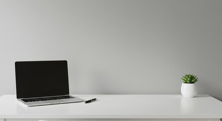 Contemporary desk setting featuring laptop, succulent and pen for office visuals