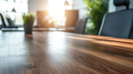 Fototapeta premium Sunlight streaming through the office window highlights a polished wooden table in a modern workspace filled with greenery and technology