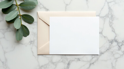 Blank white card mockup with envelope and eucalyptus leaves on white marble background, top view, flat lay,