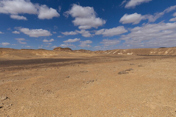 travel through the sandy desert, blue sky and many clouds