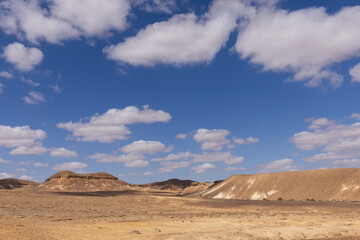 travel through the sandy desert, blue sky and many clouds