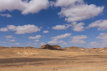travel through the sandy desert, blue sky and many clouds