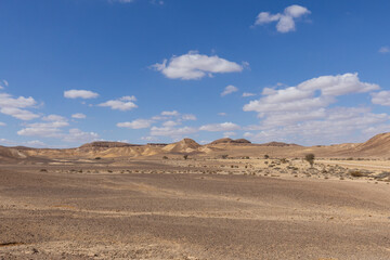 travel through the sandy desert, blue sky and many clouds