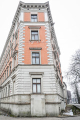 Corner of an Old Residential Building with Exposed Windows and Weathered Facade