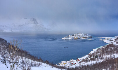 aerial photo of the village and fishing harbor of Husøy on Senja Island in northern Norway