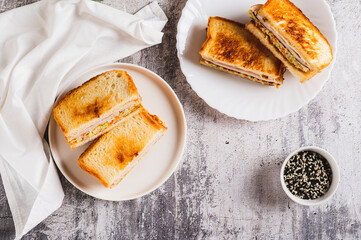 Gilgeori toast with cabbage, carrot, ham and cheese on a plate on the table top view