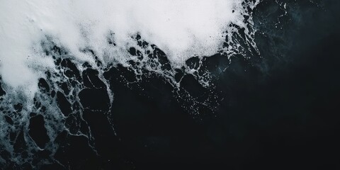 Obraz premium Mesmerizing Foam Waves on a Dark Ocean Surface Abstract Nature Coastline View From Above Aerial