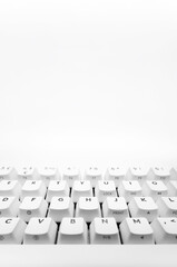 White, wireless gaming mechanical computer  keyboard closeup. Minimal, modern design on white background. Front view.  60 percent keyboard. copy space.