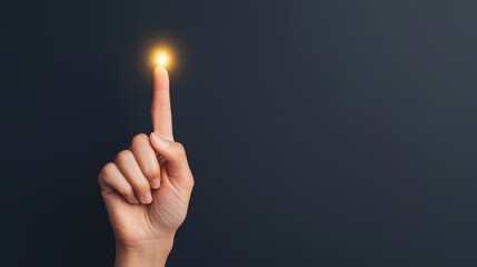Close up of a hand with index finger pointing upwards emitting a bright glowing aura of energy and light symbolizing a creative concept spiritual enlightenment or a breakthrough idea