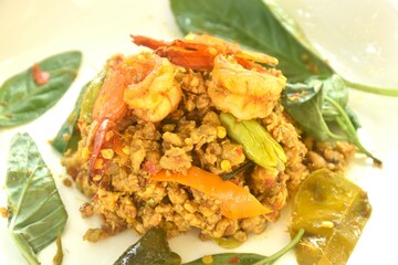 spicy fried chop pork and shrimp with turmeric curry Thai southern style food on plate