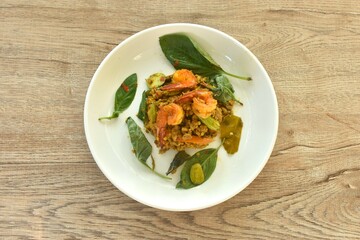 spicy fried chop pork and shrimp with turmeric curry Thai southern style food on plate