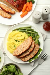 Delicious baked turkey meatloaf with mashed potato served on white wooden table, flat lay