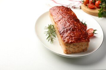 Delicious baked turkey meatloaf, rosemary, cherry tomatoes and parsley on white table, closeup. Space for text