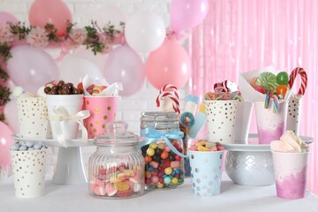 Candy bar. Many different sweets on table in festive decorated room