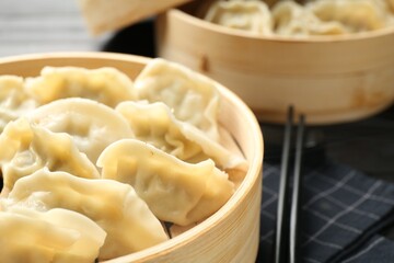 Tasty boiled gyoza (dumplings) on table, closeup