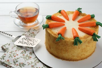 Delicious homemade carrot cake served on white wooden table