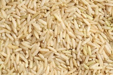 Pile of brown rice as background, top view