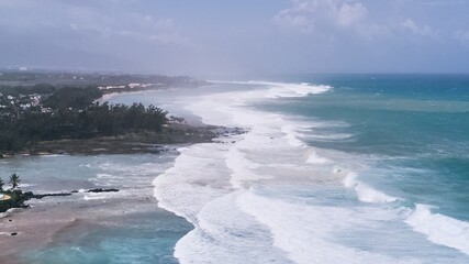 Aerial view of powerful high waves crashing in the Indian Ocean during a cyclone in Mauritius, capturing the intensity of the storm