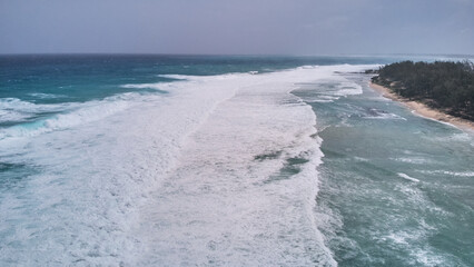 Aerial view of powerful high waves crashing in the Indian Ocean during a cyclone in Mauritius, capturing the intensity of the storm