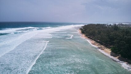 Aerial view of powerful high waves crashing in the Indian Ocean during a cyclone in Mauritius, capturing the intensity of the storm