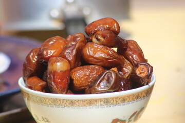 A close-up of brown dates in a bowl