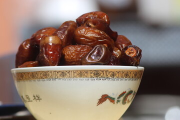A close-up of brown dates in a bowl