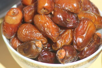 A close-up of brown dates in a bowl